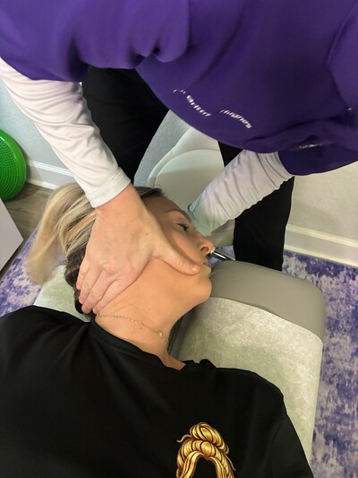 Dr. Hughes adjusting a patient's neck. 