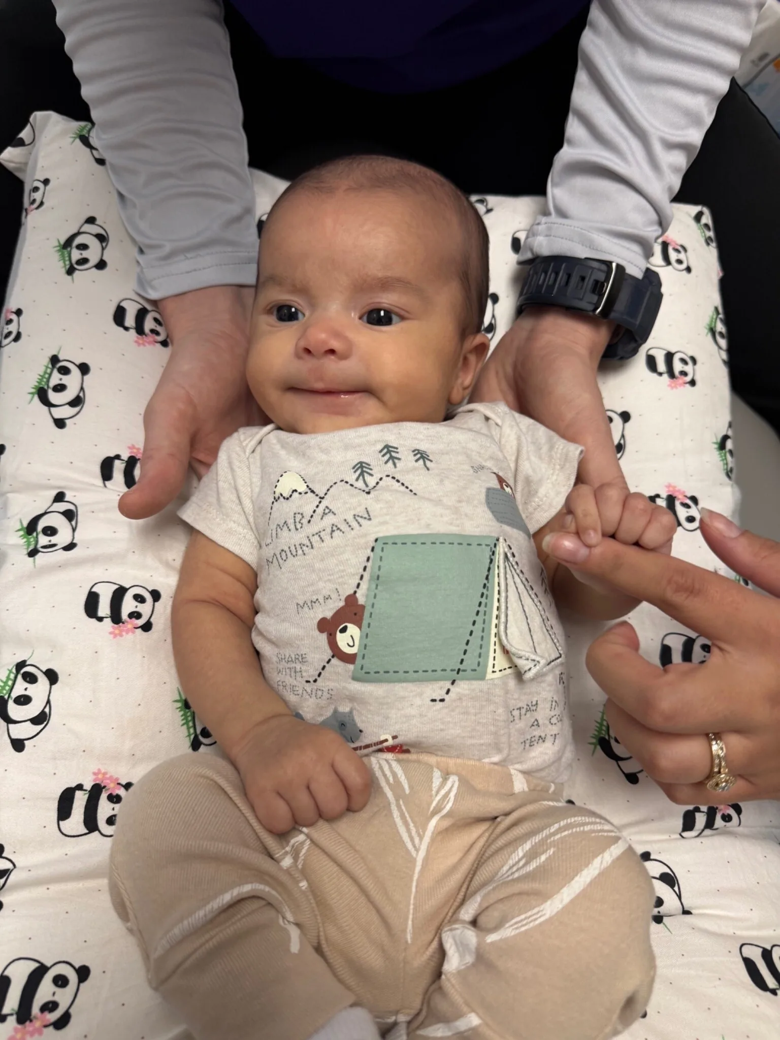 Smiling infant being held during a gentle chiropractic visit