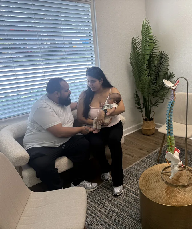 Family with their newborn during a specialized chiropractic care consultation at Spinal Health Center in Vero Beach